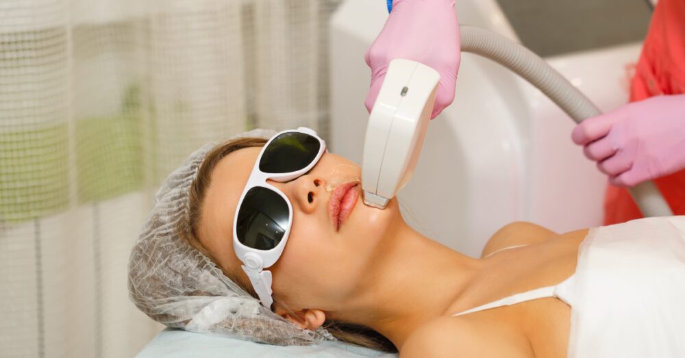 Patient receiving professional laser hair removal treatment on her chin