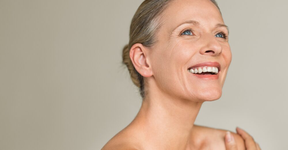 Happy mature woman with glowing skin smiling