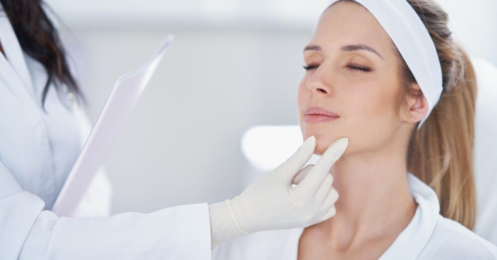 Provider assessing a female’s jawline