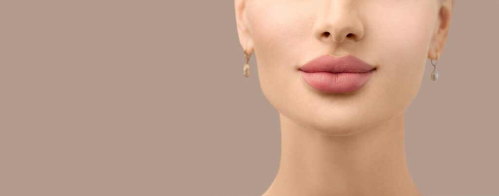 beautiful young woman with full lips closeup after lip filler injection