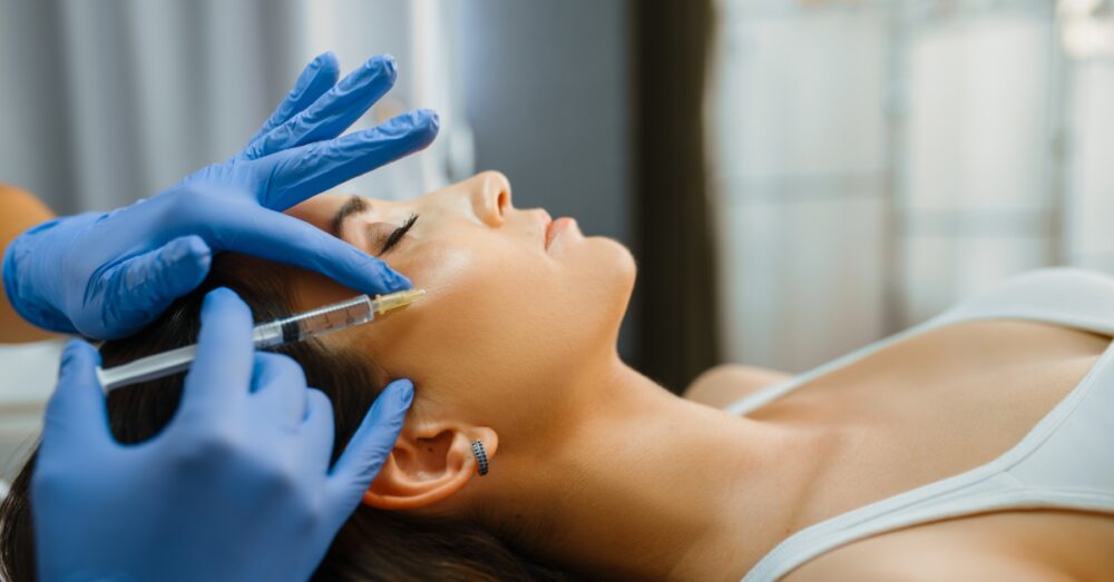 A woman receiving a professional facial treatment at a med spa